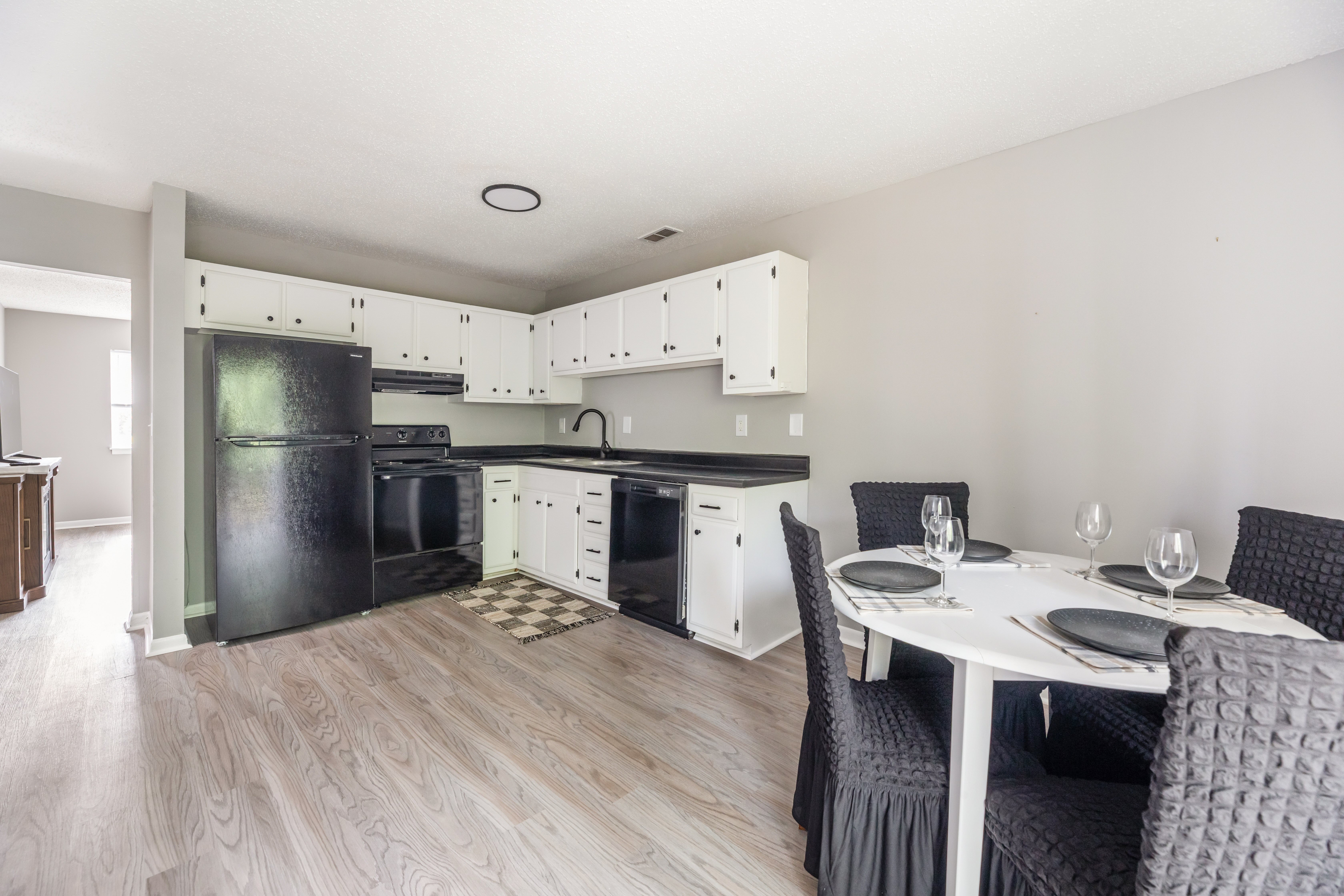 A modern kitchen with a dining table set for two.at Lauradale, Jacksonville